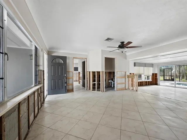 a view of an empty room with a fireplace and a large window