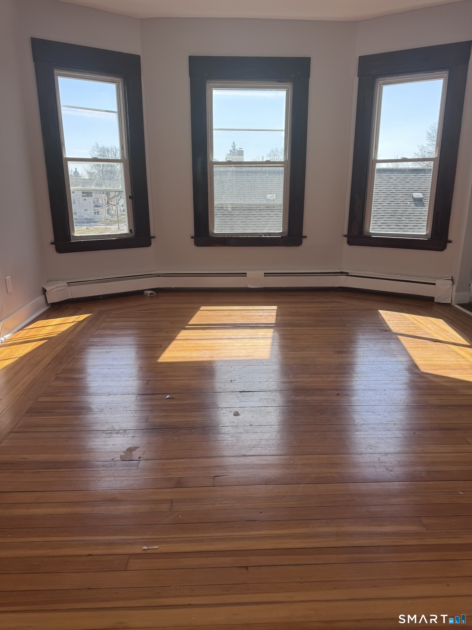 283 Martin Street Hartford, CT 06120 - Photo 6 of 16 a view of empty room with wooden floor and fan
