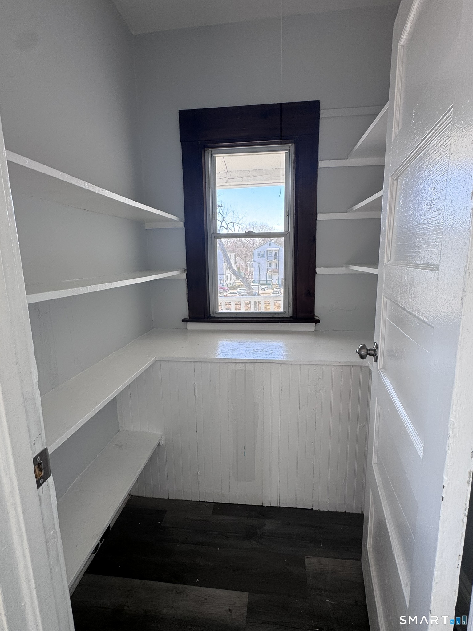 283 Martin Street Hartford, CT 06120 - Photo 9 of 16 a view of storage and utility room with wooden floor and window