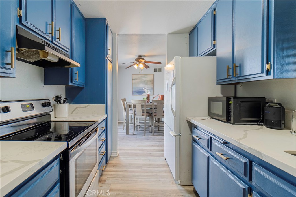 874 Cinnamon Lane, Unit 62 Duarte, CA 91010 - Photo 1 of 22 a kitchen with a sink a stove and cabinets