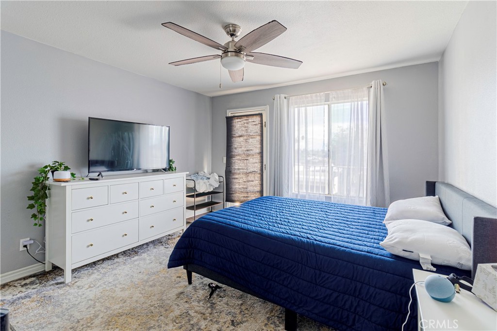 874 Cinnamon Lane, Unit 62 Duarte, CA 91010 - Photo 7 of 22 a bedroom with a bed and flat screen tv