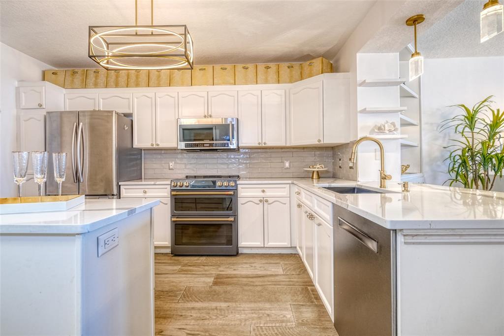 16600 Gulf Boulevard, Unit 536 North Redington Beach, FL 33708 - Photo 11 of 46 a kitchen with stainless steel appliances a stove sink and cabinets