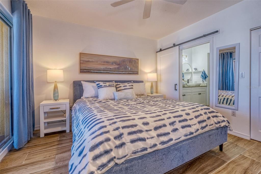 16600 Gulf Boulevard, Unit 536 North Redington Beach, FL 33708 - Photo 20 of 46 a bedroom with a bed and a painting on the wall