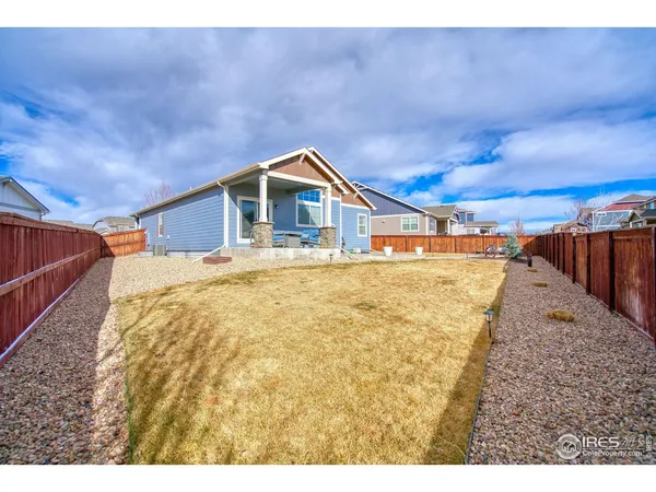 a view of a backyard with wooden fence