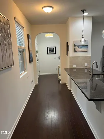 a kitchen with stainless steel appliances granite countertop a sink a stove and a refrigerator