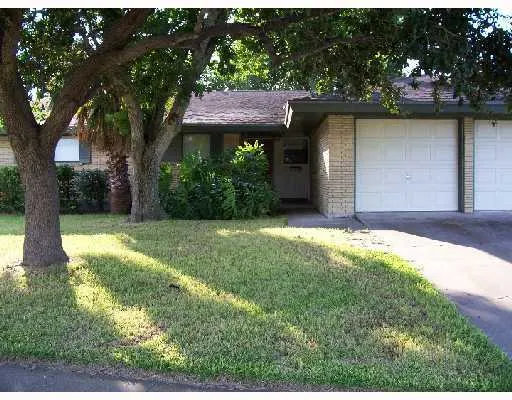 a front view of house with yard and trees