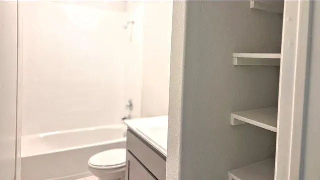 an empty room with windows and closet