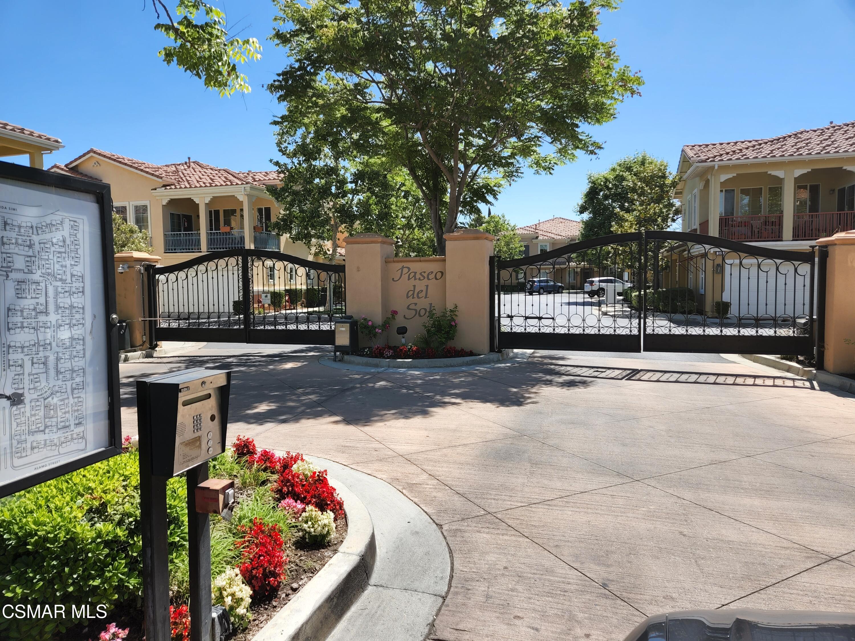 a view of a house with wooden fence