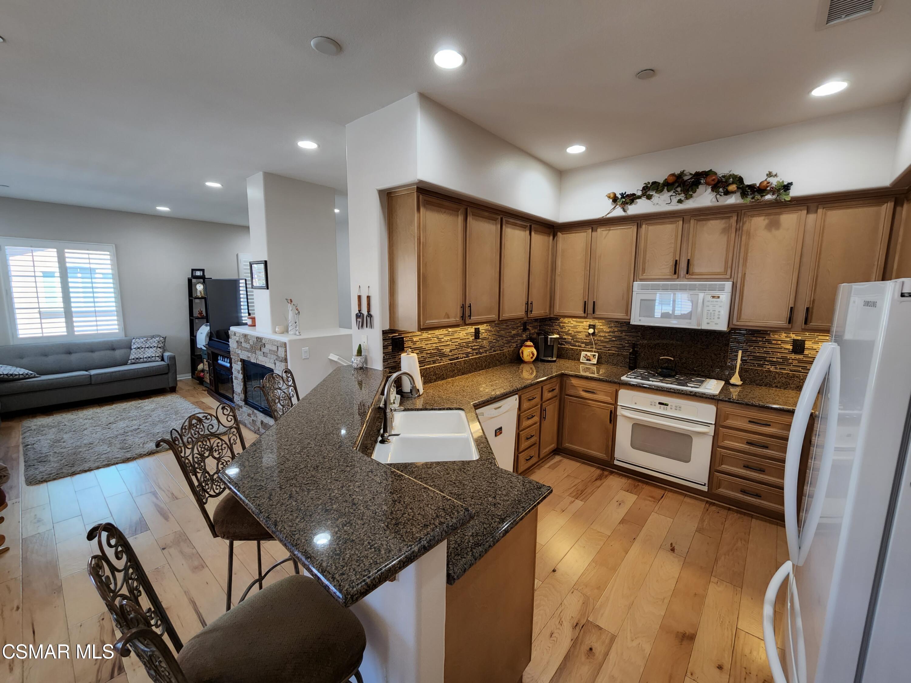 4121 Paredo Way, Unit D Simi Valley, CA 93063 - Photo 11 of 35 a kitchen with granite countertop lots of counter top space and stainless steel appliances