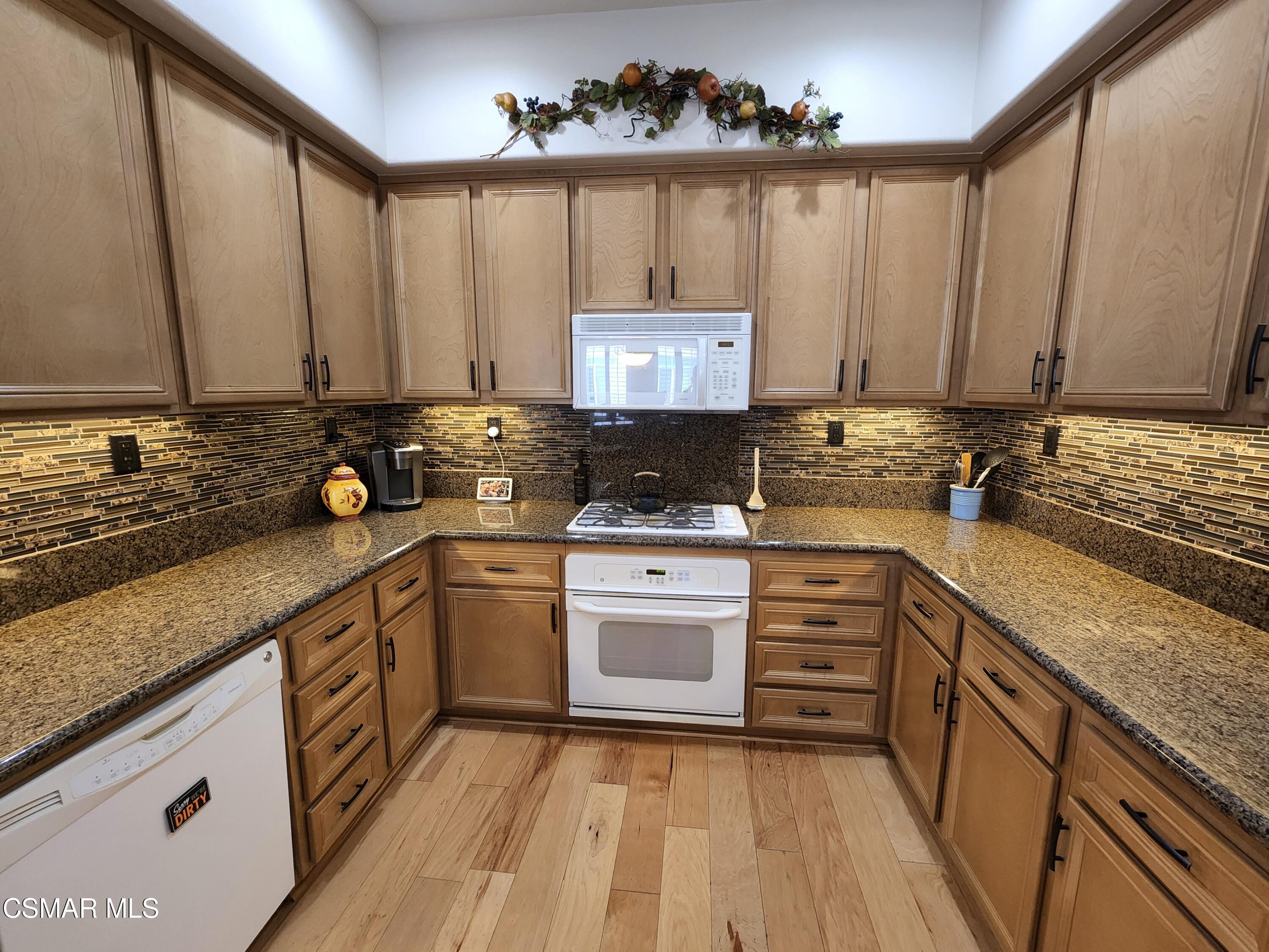 4121 Paredo Way, Unit D Simi Valley, CA 93063 - Photo 12 of 35 a kitchen with a sink stove and cabinets