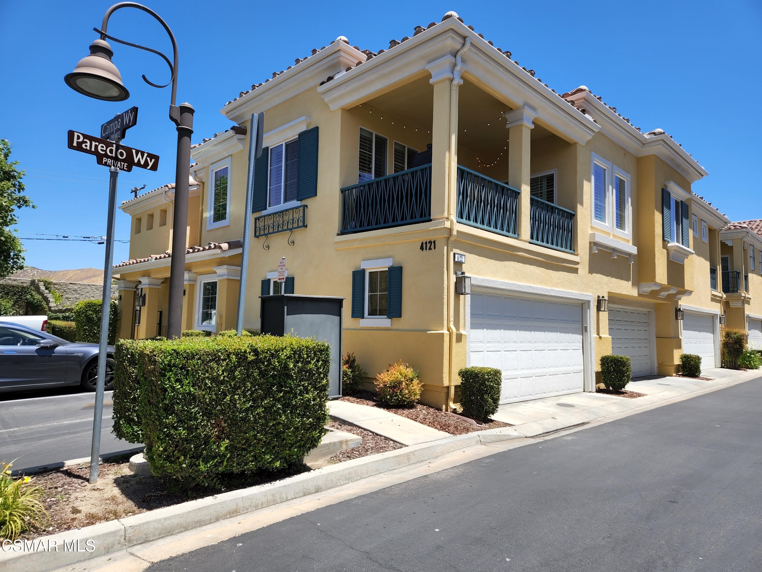4121 Paredo Way, Unit D Simi Valley, CA 93063 - Photo 2 of 35 a front view of a house with a yard