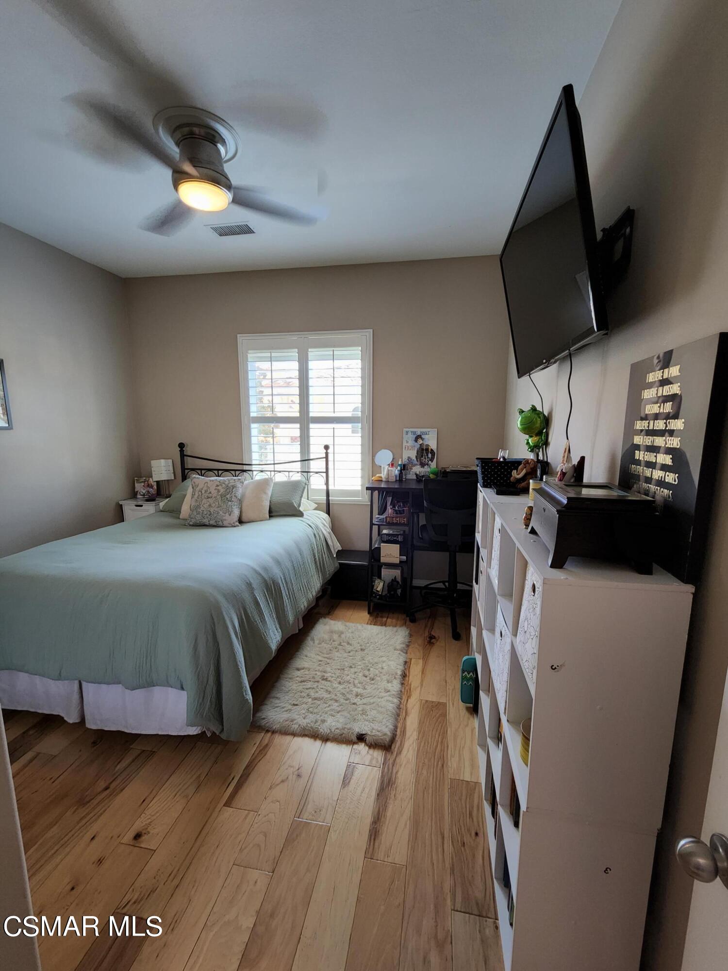 4121 Paredo Way, Unit D Simi Valley, CA 93063 - Photo 22 of 35 a bedroom with a bed a flat screen tv and windows