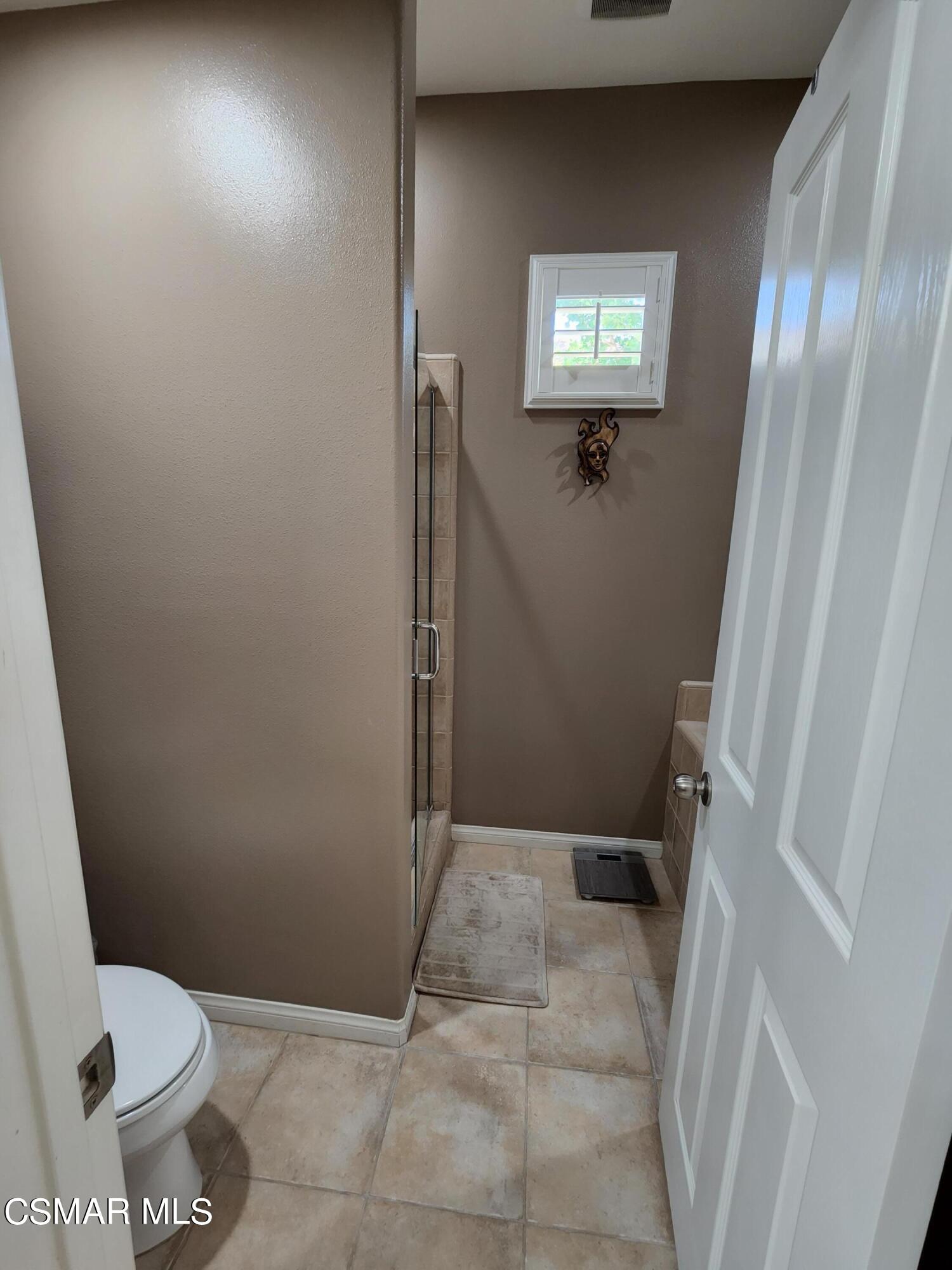 4121 Paredo Way, Unit D Simi Valley, CA 93063 - Photo 30 of 35 a bathroom with a toilet and a shower