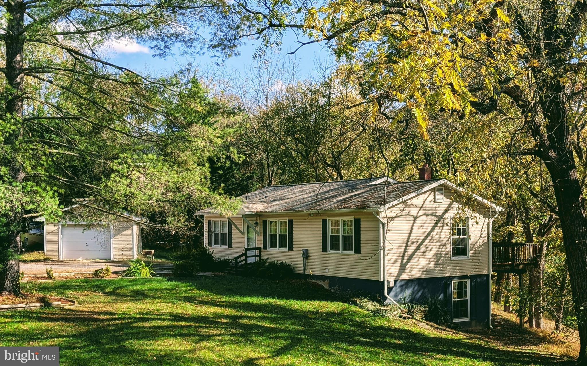 a front view of a house with a garden and trees
