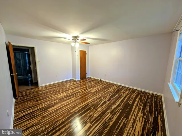 a view of a room with a ceiling fan