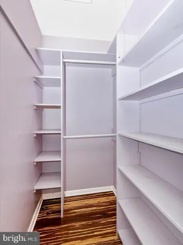 a view of walk in closet with empty racks