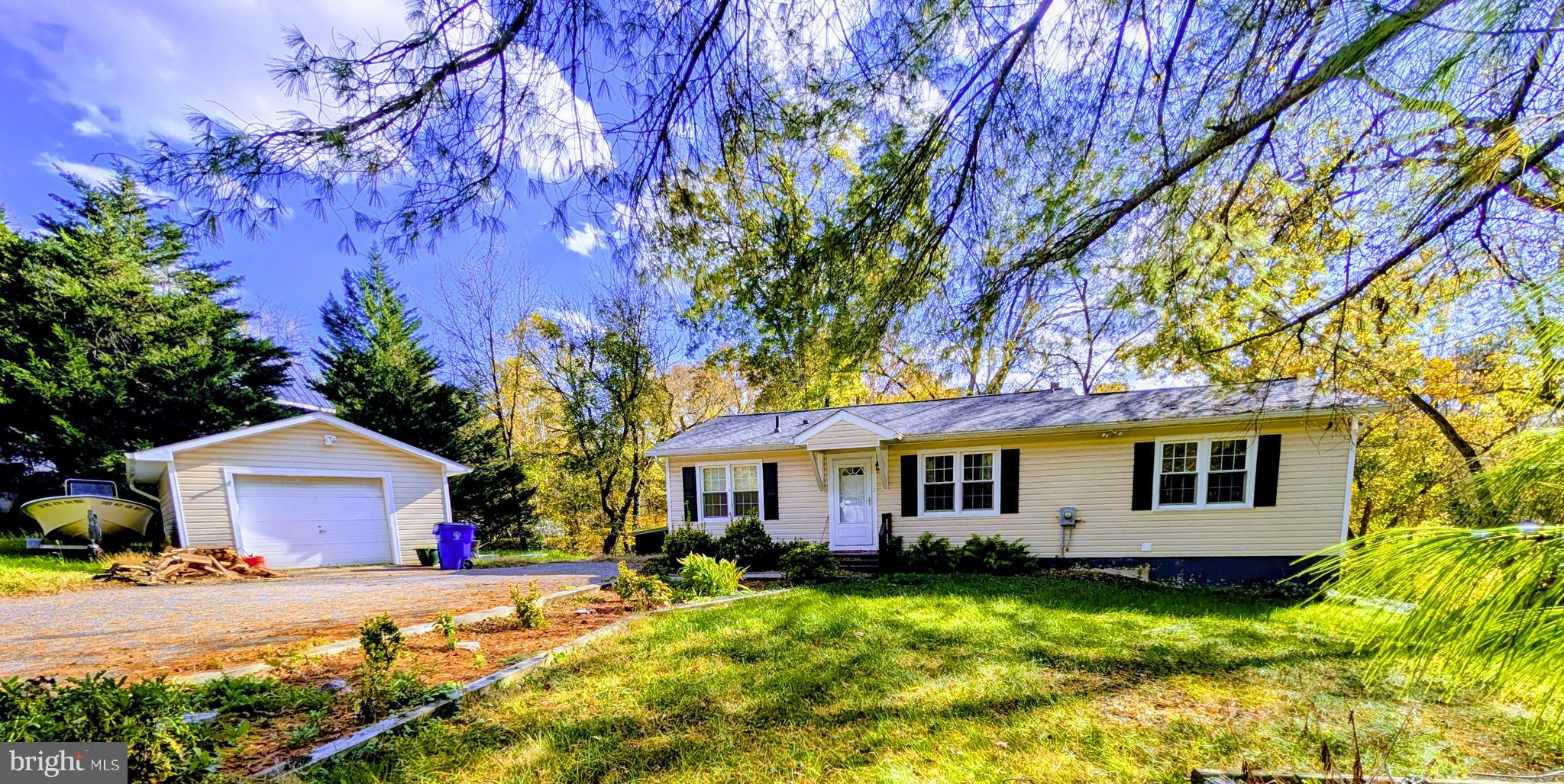 7403 Bear Branch Road Adamstown, MD 21710 - Photo 2 of 43 a front view of a house with a yard and garage