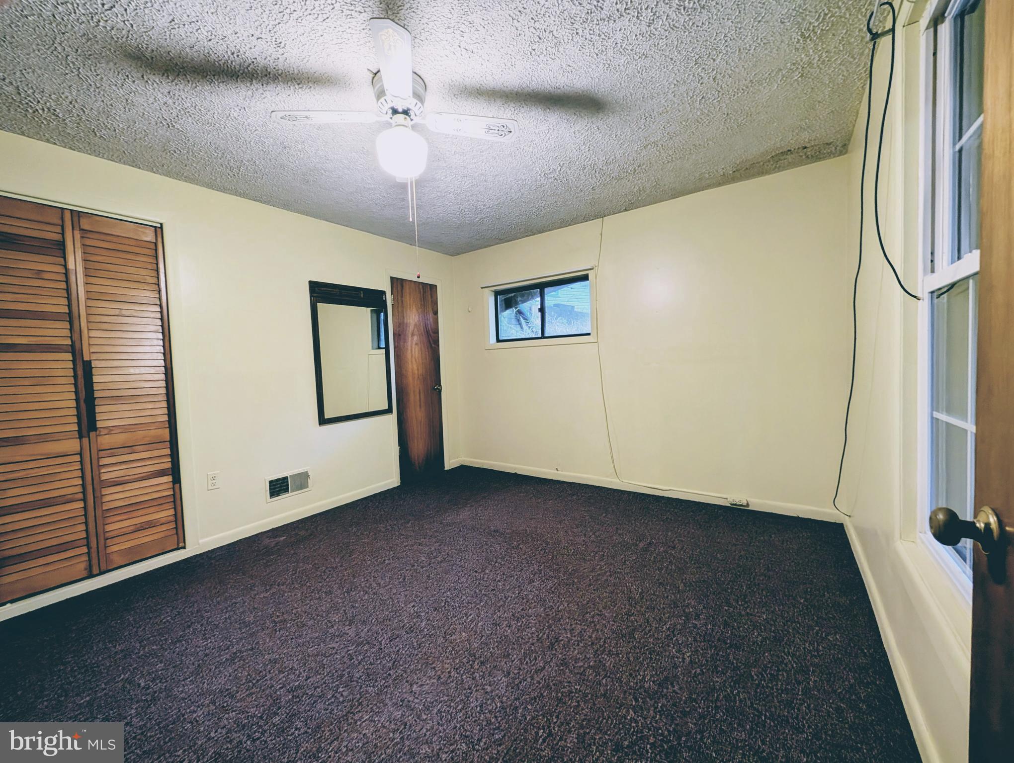 7403 Bear Branch Road Adamstown, MD 21710 - Photo 21 of 43 a view of a livingroom with an entryway and a ceiling fan