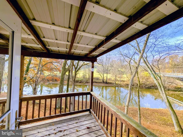 a view of a backyard with wooden fence