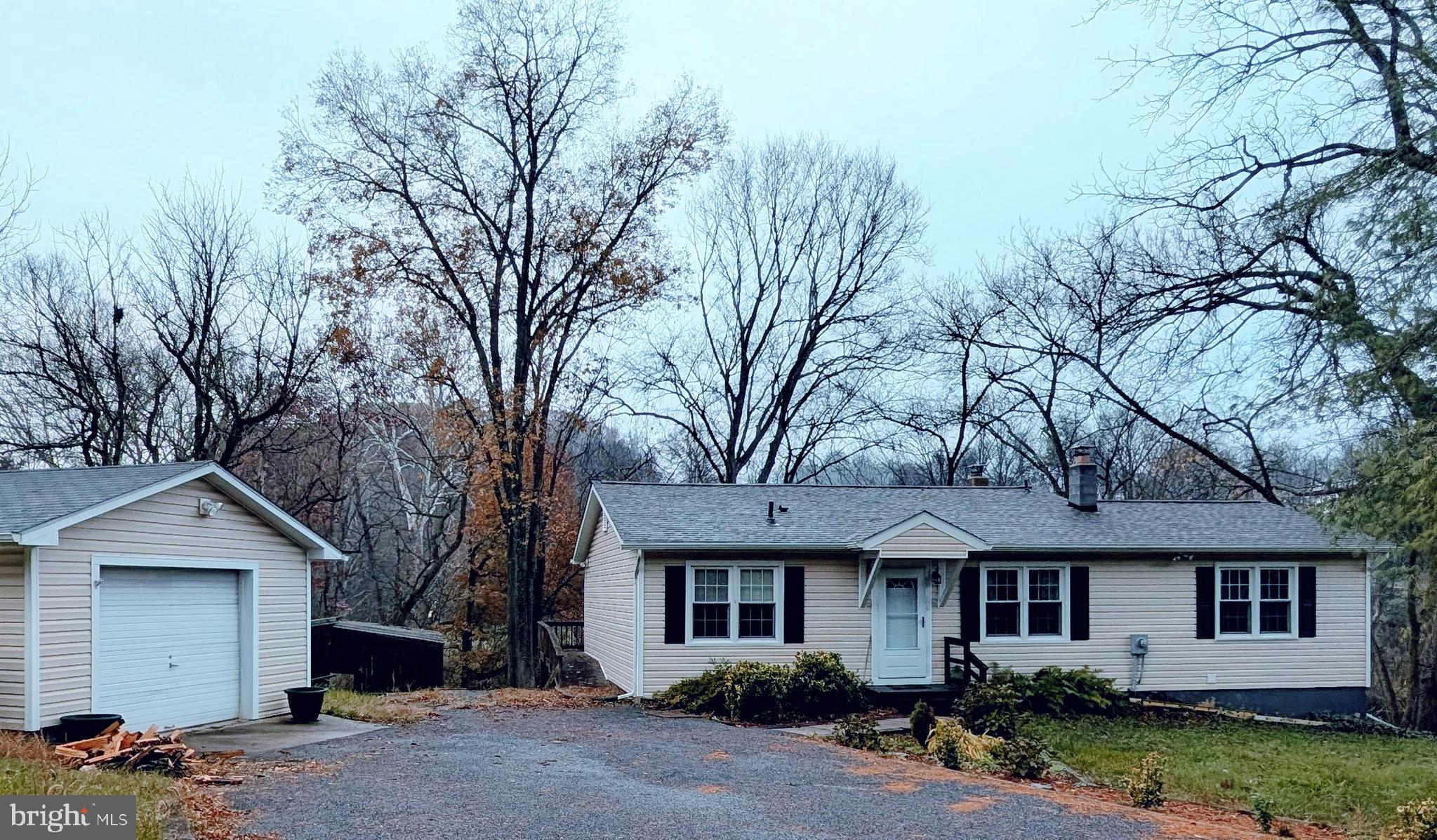 7403 Bear Branch Road Adamstown, MD 21710 - Photo 37 of 43 a front view of a house with a garden