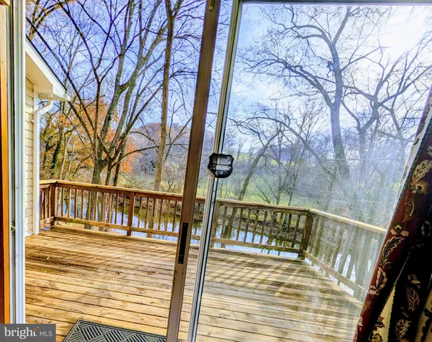 a view of balcony with wooden floor and fence