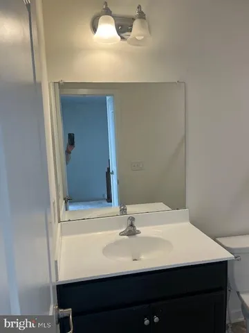 a bathroom with a sink vanity and a mirror