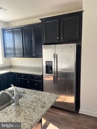 a kitchen with a refrigerator stove and cabinets