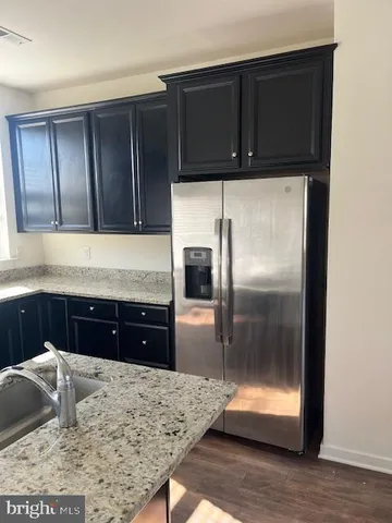 a kitchen with a refrigerator stove and cabinets
