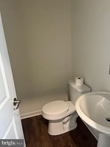 a white toilet sitting next to a white sink