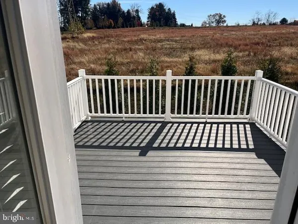 a view of balcony with wooden floor