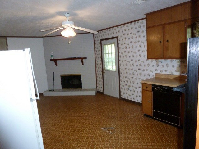 6552 Vinson Road Macon, GA 31216 - Photo 8 of 20 a view of an empty room with a fireplace and a window