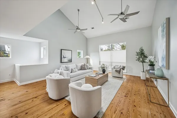 a living room with furniture a chandelier and a window