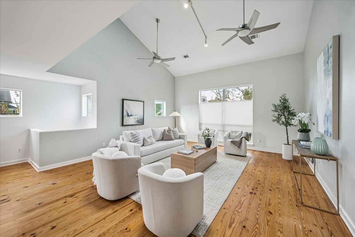 a living room with furniture a chandelier and a window