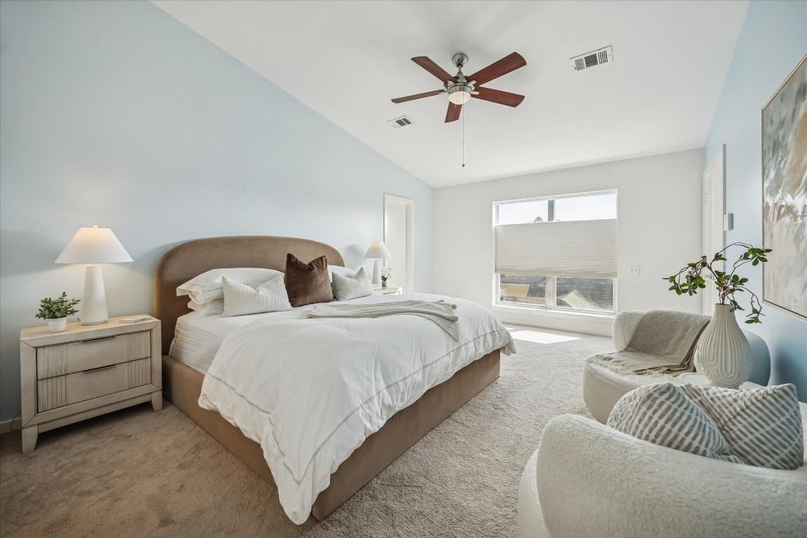 2508 Calumet Street, Unit E Houston, TX 77004 - Photo 11 of 31 a spacious bedroom with a bed a couch and a chandelier