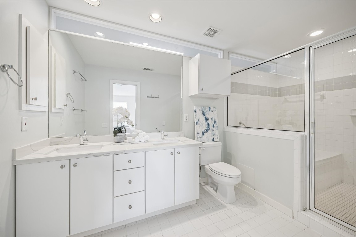 2508 Calumet Street, Unit E Houston, TX 77004 - Photo 13 of 31 a spacious bathroom with a double vanity sink toilet and a mirror