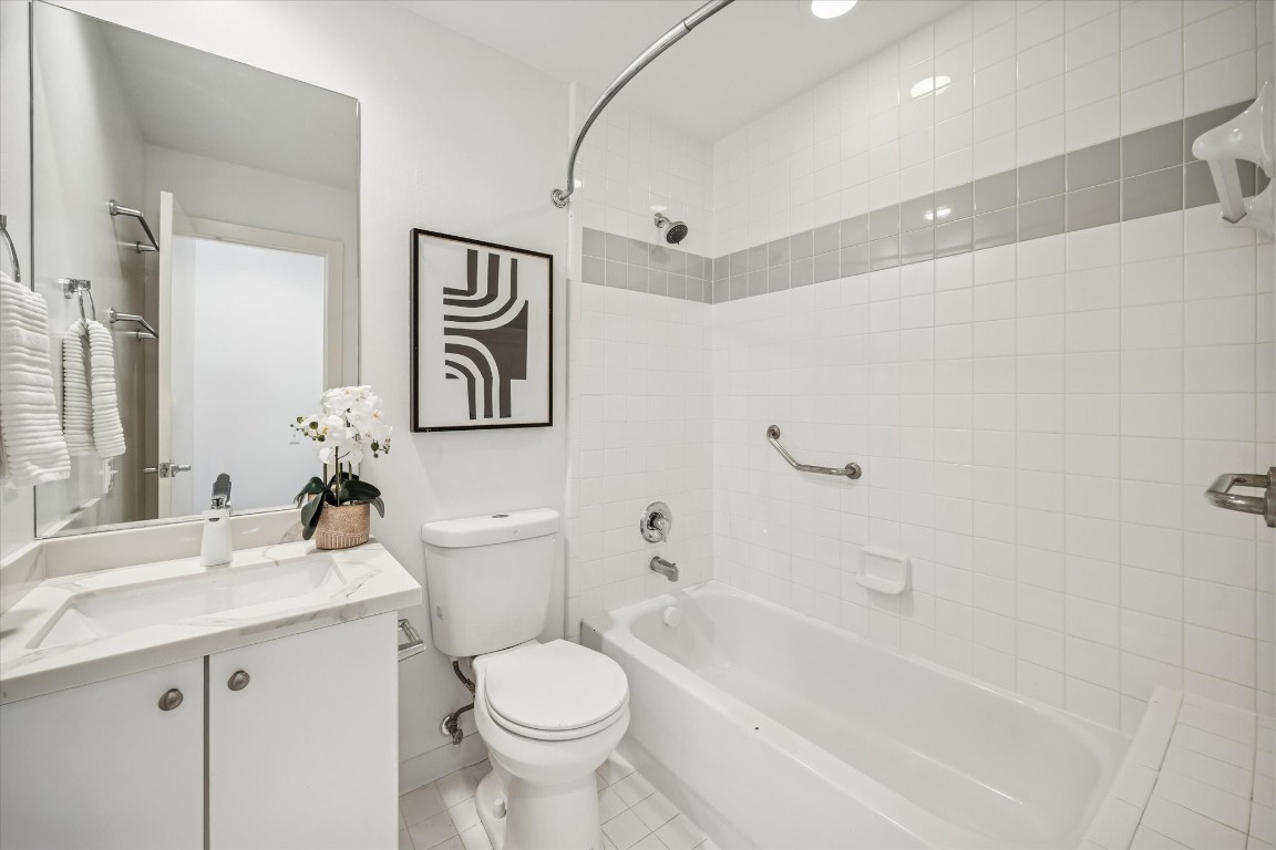 2508 Calumet Street, Unit E Houston, TX 77004 - Photo 23 of 31 a bathroom with a toilet sink and mirror
