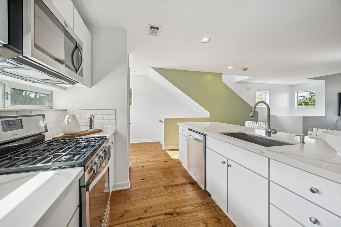 2508 Calumet Street, Unit E Houston, TX 77004 - Photo 9 of 31 a kitchen with a sink and cabinets