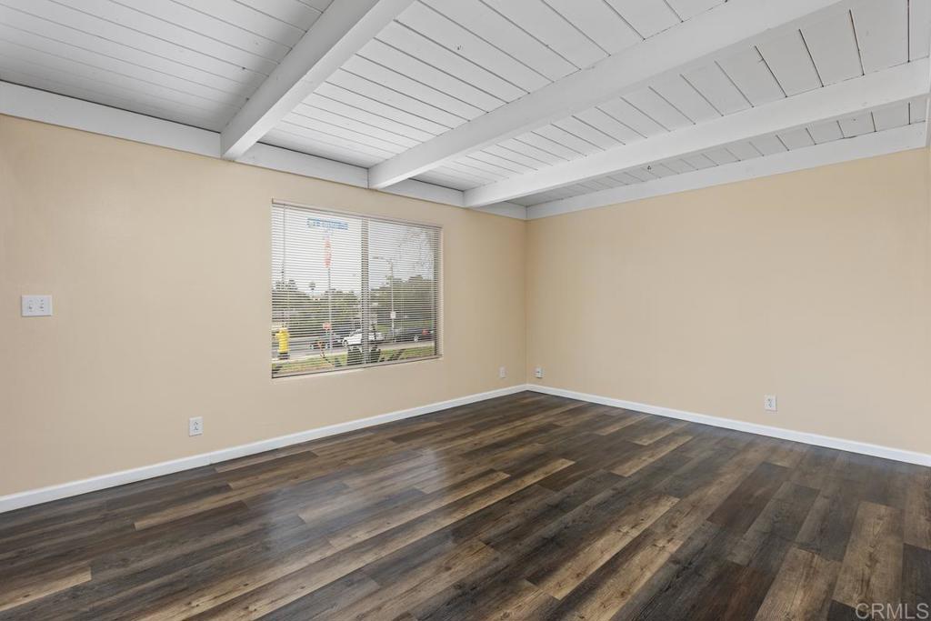 921 Lemon Avenue Vista, CA 92084 - Photo 6 of 32 a view of an empty room with wooden floor and a window