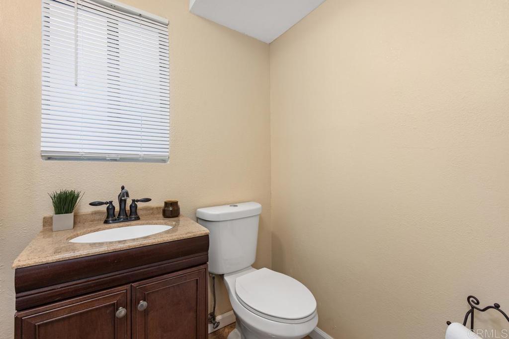 921 Lemon Avenue Vista, CA 92084 - Photo 8 of 32 a bathroom with a sink a toilet and a mirror