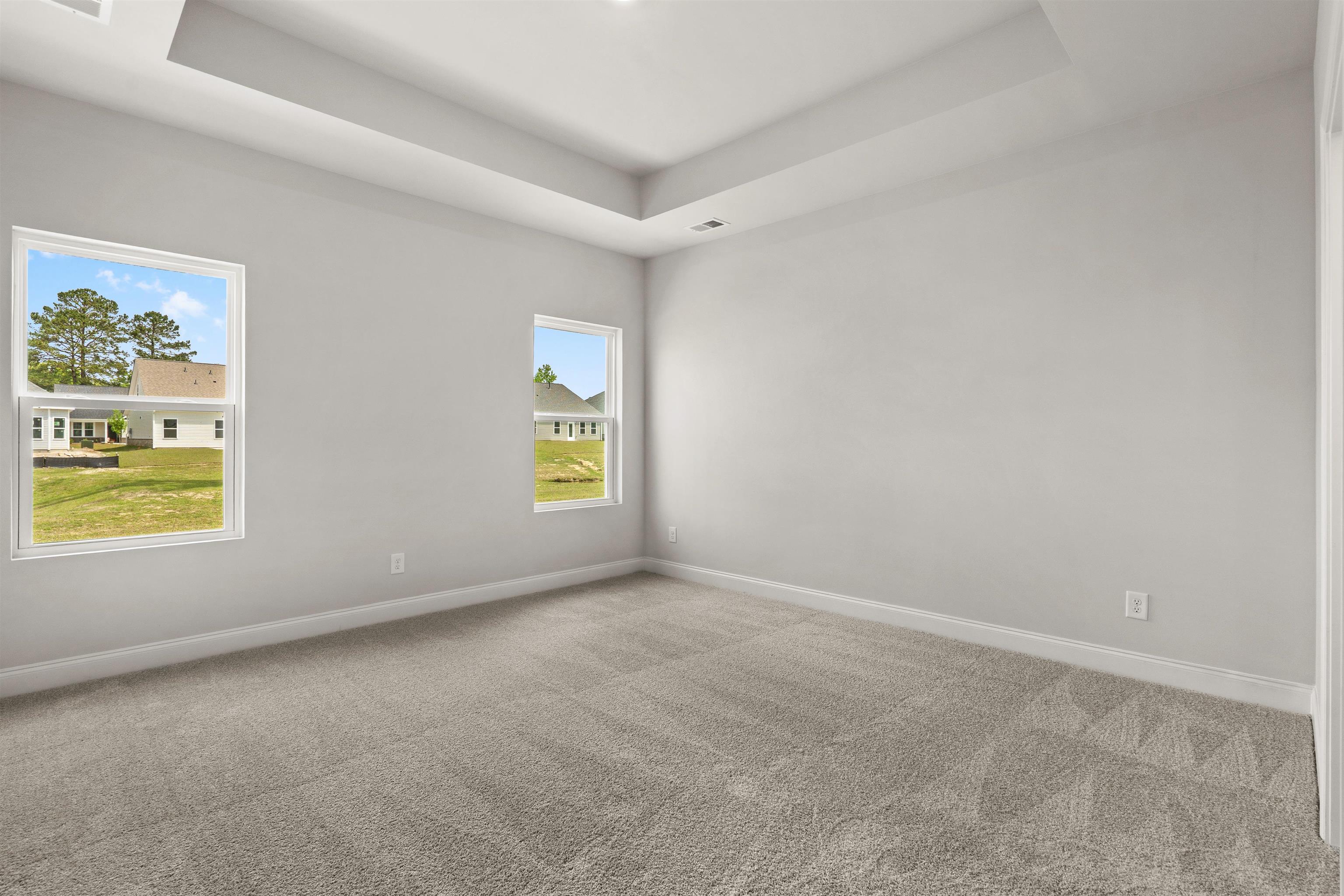 2495 Campton Loop Conway, SC 29527 - Photo 11 of 27 Empty room with a tray ceiling and carpet
