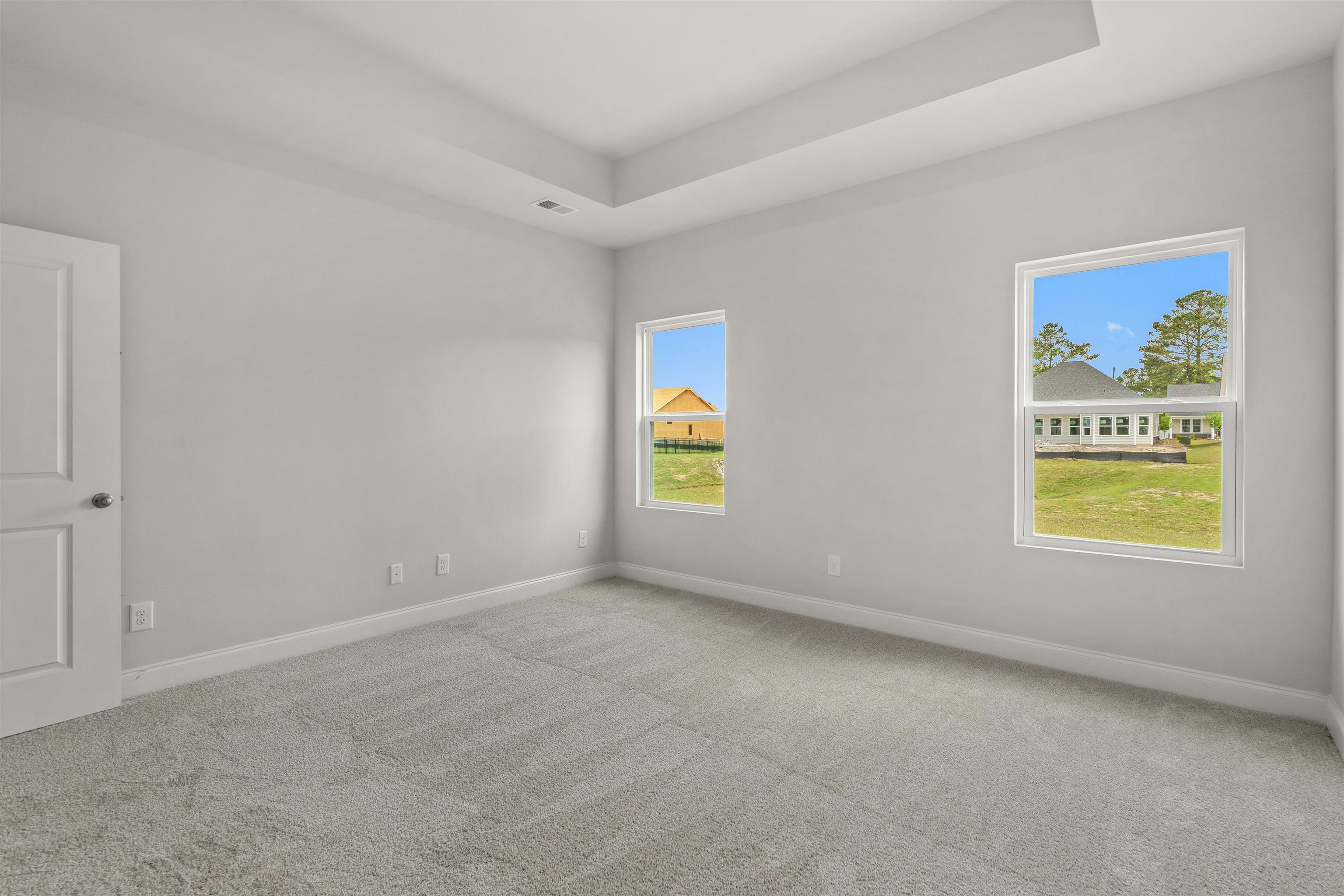 2495 Campton Loop Conway, SC 29527 - Photo 15 of 27 Empty room featuring light colored carpet and a tray ceiling