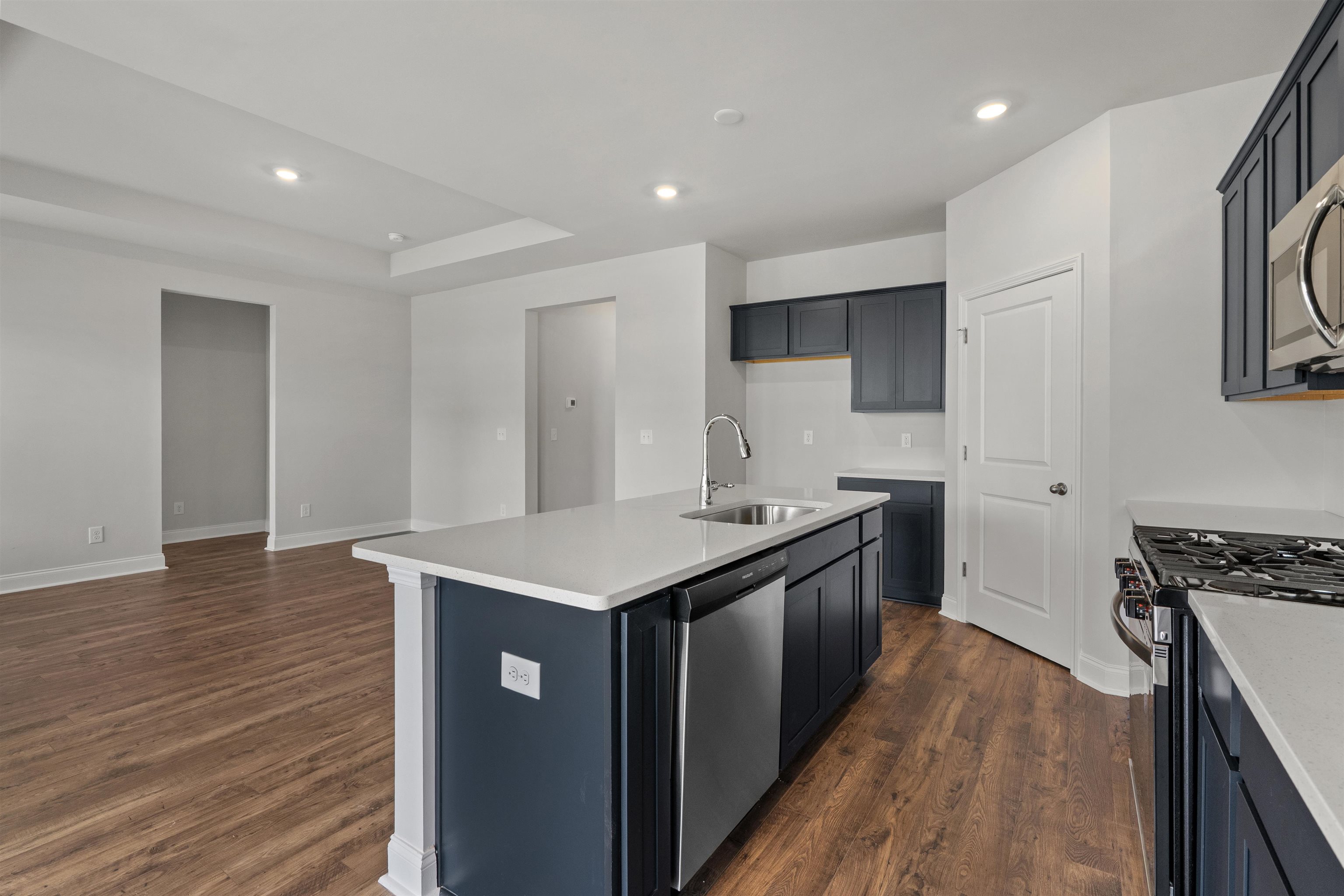 2495 Campton Loop Conway, SC 29527 - Photo 3 of 27 Kitchen featuring recessed lighting, stainless steel appliances, a center island with sink, dark wood-type flooring, and light stone counters