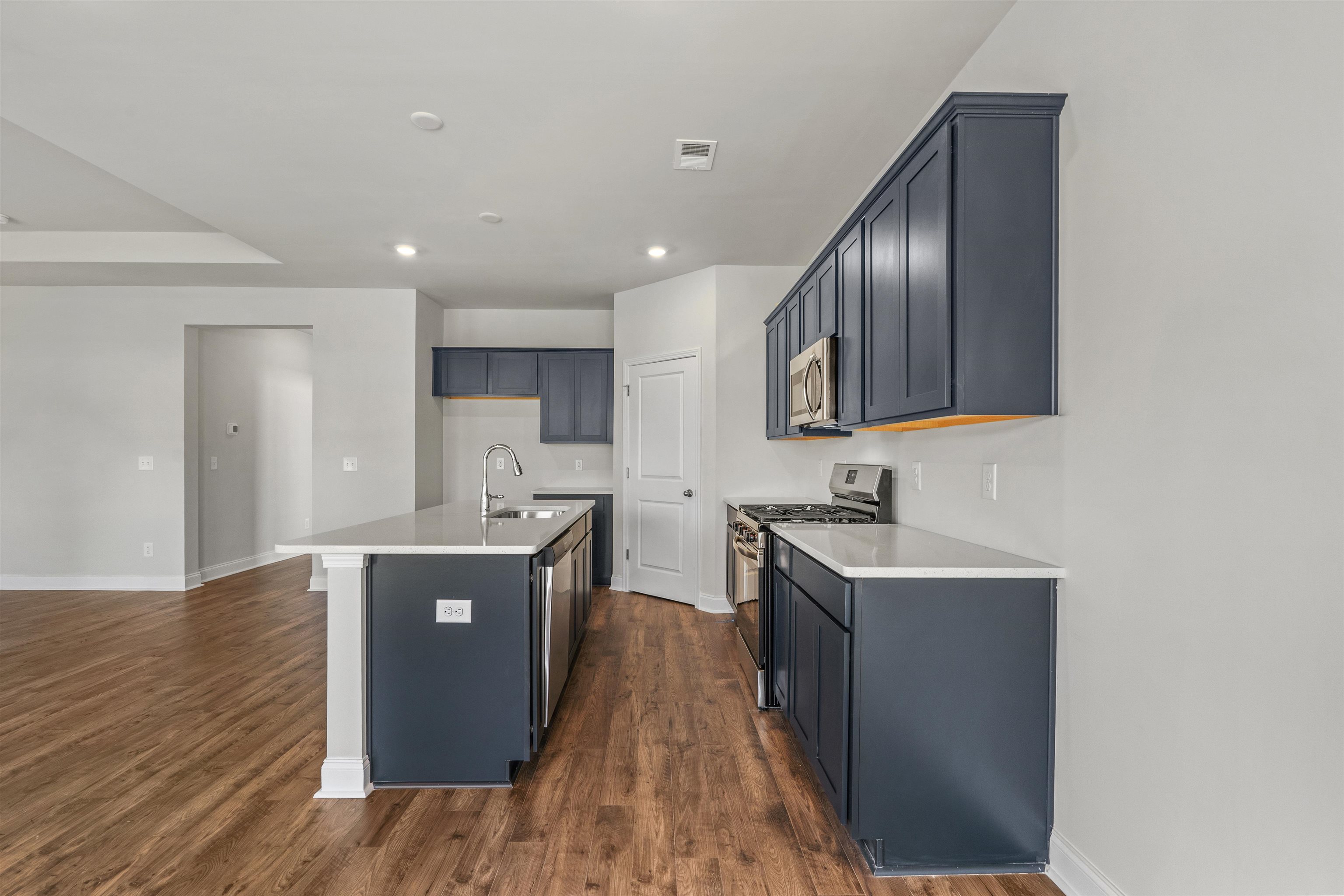 2495 Campton Loop Conway, SC 29527 - Photo 5 of 27 Kitchen featuring stainless steel appliances, an island with sink, dark wood finished floors, light stone countertops, and recessed lighting