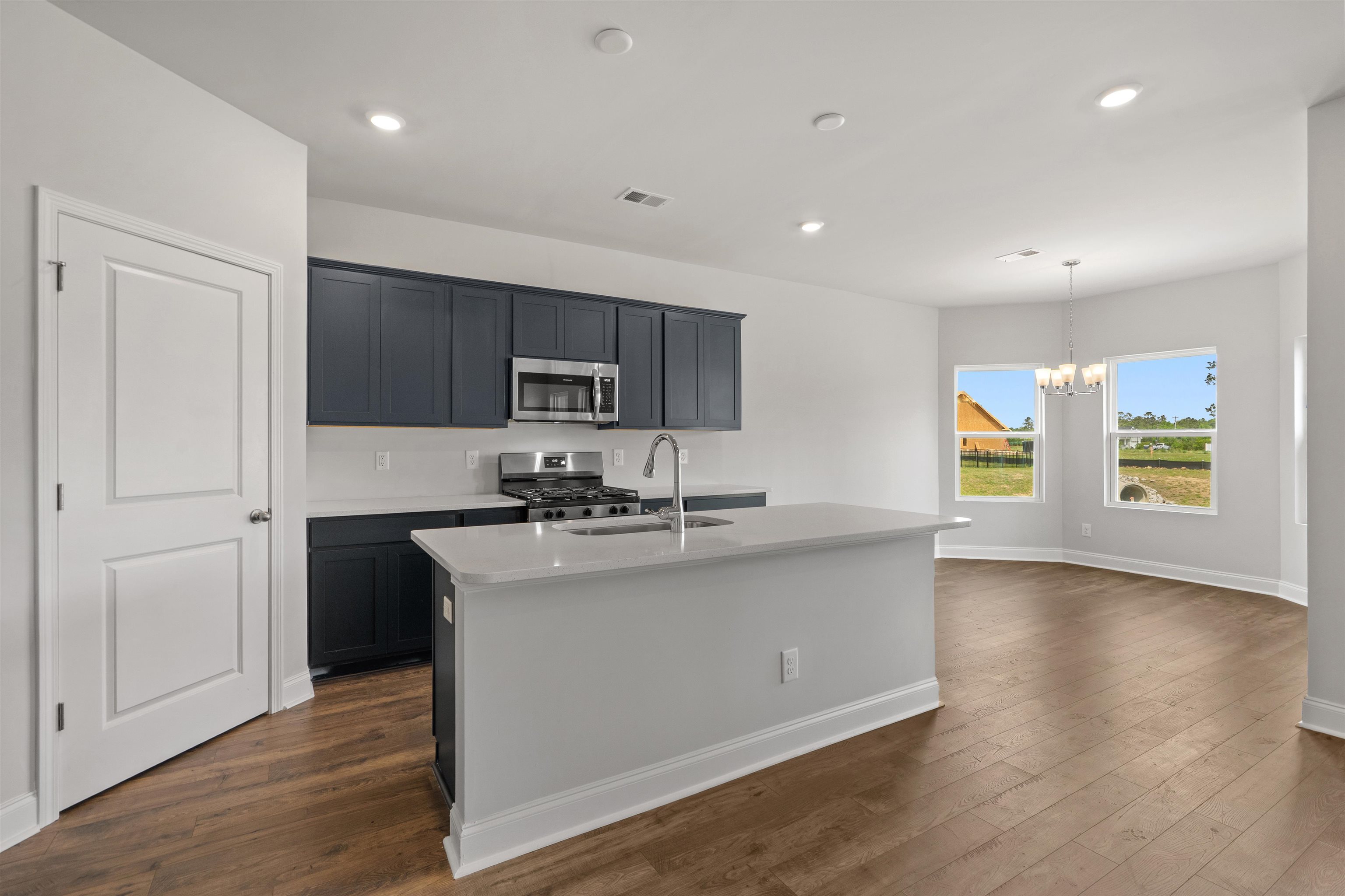 2495 Campton Loop Conway, SC 29527 - Photo 6 of 27 Kitchen featuring appliances with stainless steel finishes, a center island with sink, hanging light fixtures, recessed lighting, and dark wood finished floors