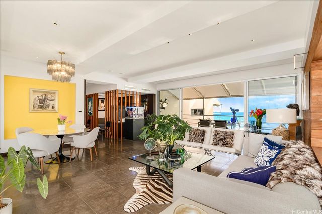 a kitchen with stainless steel appliances a stove top oven a sink a refrigerator white cabinets and wooden floor