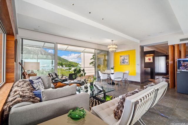 a living room with furniture and a floor to ceiling window