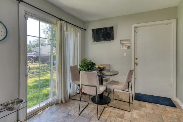 a view of a livingroom with furniture and a window