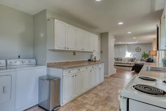 a kitchen with a sink stove and cabinets