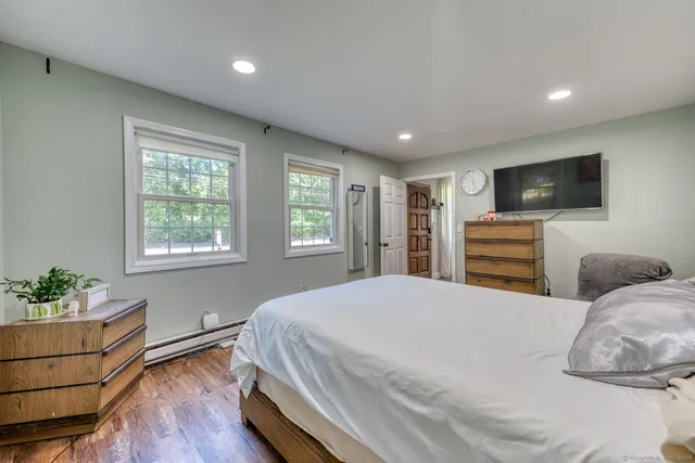 a bedroom with a bed and a flat screen tv