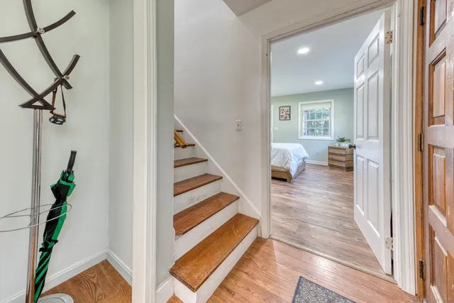 a view of entryway and hall with wooden floor